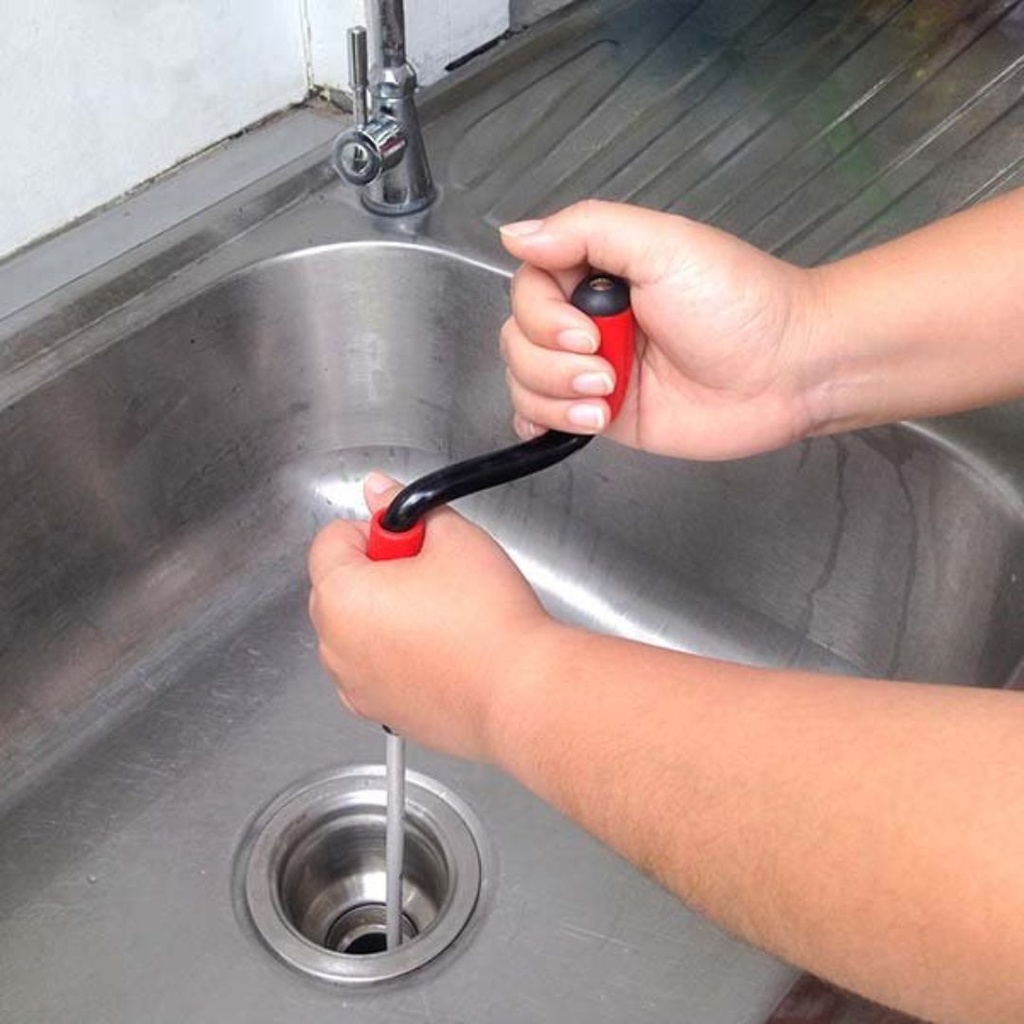 Replacement Service for repairing the drain pipe of the kitchen sink using a pipe auger